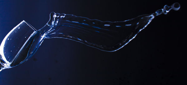 Close-up of water drops on glass against black background