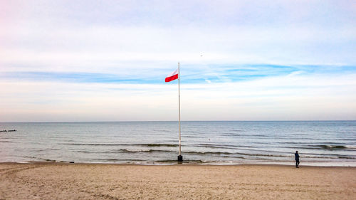 Full length of man standing on beach against sky