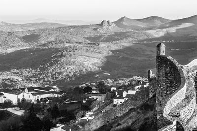 High angle view of townscape and mountains against sky