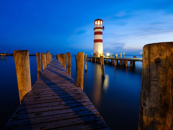 Pier over sea against blue sky