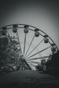 Low angle view of ferris wheel against sky