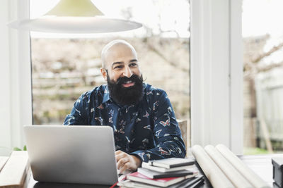 Portrait of young man using laptop