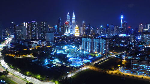 High angle view of city lit up at night