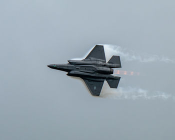 Low angle view of airplane flying against sky