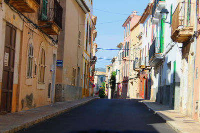 Alley amidst street against sky