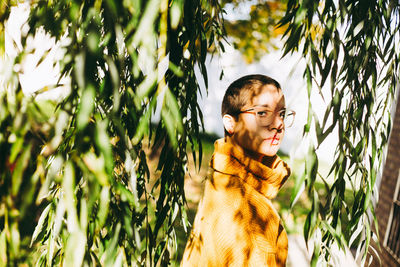 Portrait of man standing against plants