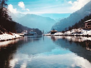 Scenic view of lake and mountains against sky