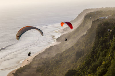 People paragliding against sky