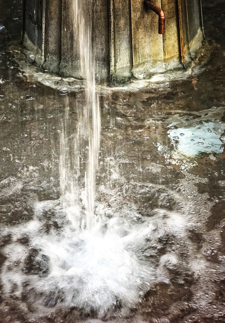 CLOSE-UP OF WATER SPLASHING AGAINST WATERFALL