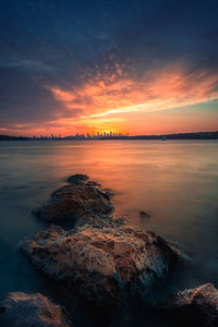 Scenic view of sea against romantic sky at sunset