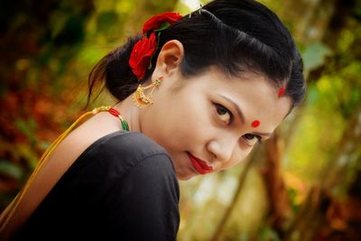 Portrait of young woman lying down on land