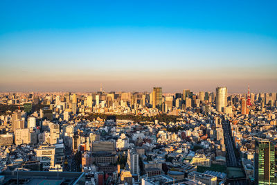 High angle view of modern buildings in city against clear sky