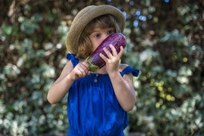 Portrait of boy holding hat