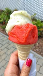 Close-up of hand holding ice cream cone