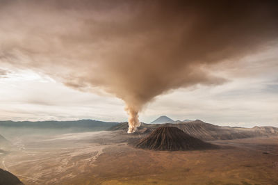 View of volcanic landscape against cloudy sky