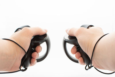 Close-up of man holding hands over white background