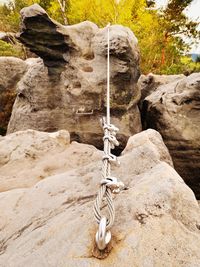 Iron twisted rope between rocks in climbers path via ferrata. rope fixed in block by screws hooks