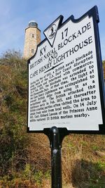 View of information sign against sky