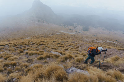 Side view of man walking on mountain