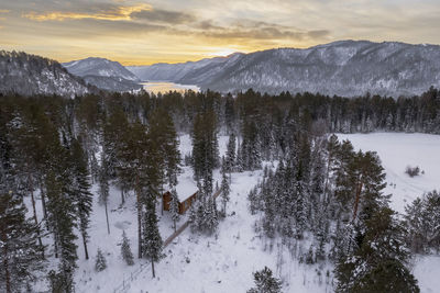 Scenic view of snowcapped mountains against sky during sunset