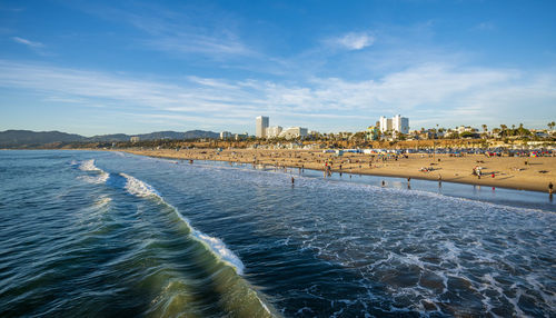 Waves crashing in to the beach on a sunny day