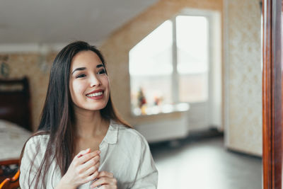 Reflection of smiling young woman in mirror