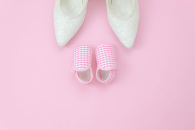 High angle view of shoes against pink background