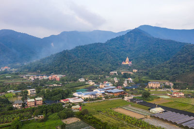 High angle view of buildings and mountains against sky