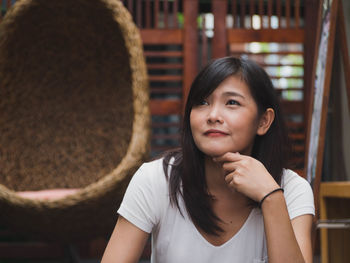 Thoughtful woman sitting outdoors