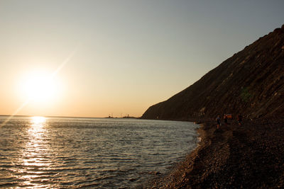 Scenic view of sea against clear sky during sunset