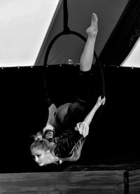 Midsection of woman with arms raised at home