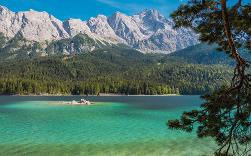 Scenic view of lake and snowcapped mountains against sky