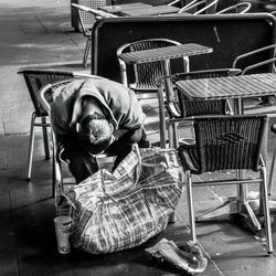 High angle view of man with basket sitting on chair