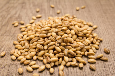 Close-up of barley grains on wooden table