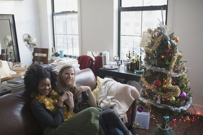 A young couple by a christmas tree