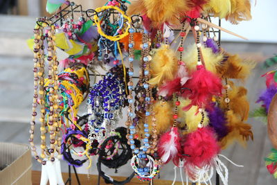 Close-up of multi colored decorations hanging at market stall