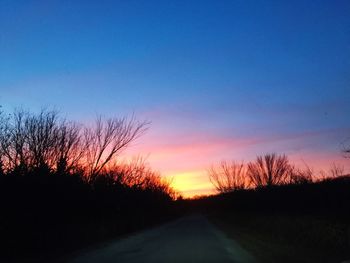 Silhouette bare trees against sky during sunset