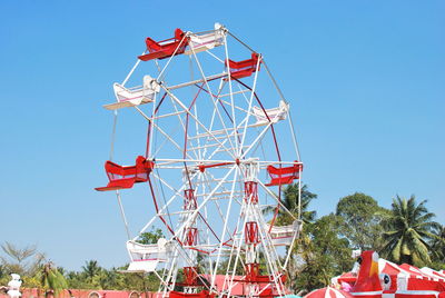 Low angle view of ferris wheel against clear sky