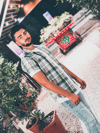 High angle portrait of young man standing outdoors