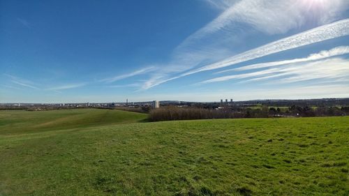 Scenic view of soccer field against blue sky