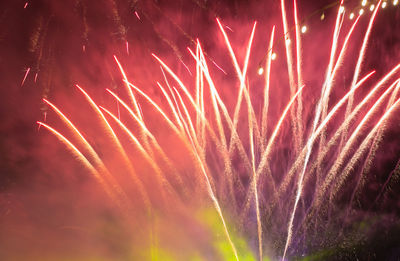 Low angle view of firework display at night