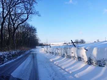 Snow covered road against sky