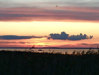 Scenic view of silhouette field against sky during sunset