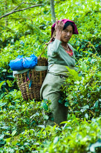 Woman standing against plants