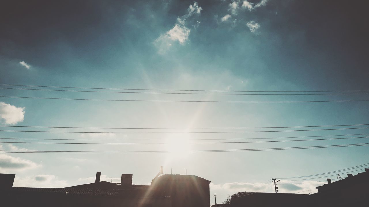 sky, cloud - sky, cable, low angle view, power line, electricity, sunlight, built structure, architecture, nature, sunbeam, building exterior, sun, no people, lens flare, day, power supply, fuel and power generation, connection, building, outdoors, bright, brightly lit, solar flare