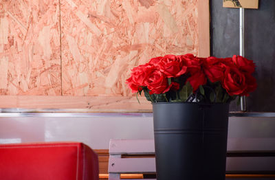 Close-up of red rose flower vase on table