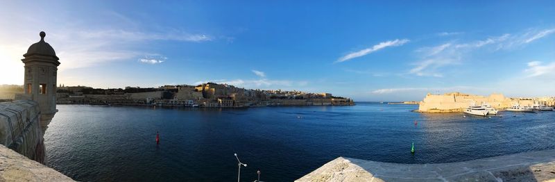 Panoramic view of sea and buildings against sky