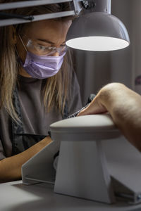 Midsection of woman using mobile phone on table