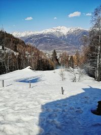 Snow covered land against sky