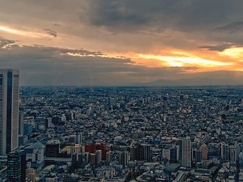 High angle view of modern buildings against sky during sunset